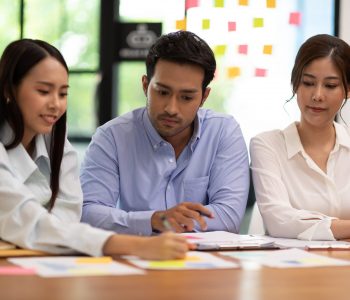 Group of young Startup coworkers working together to get ideas and marketing at office,Business Startup Diversity Brainstorming Concept