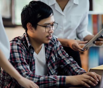 Young students learning,library bookshelves on background